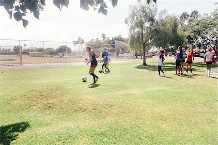 simsearch:614-09079015,k - Male teacher doing soccer practice with schoolgirls on school sports field Stock Photo - Premium Royalty-Free, Code: 614-09078938