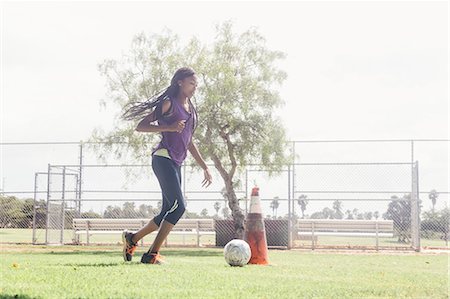 simsearch:614-09079031,k - Teenage schoolgirl doing dribbling soccer ball practice on school sports field Stock Photo - Premium Royalty-Free, Code: 614-09078942