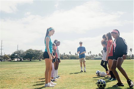 simsearch:614-09078963,k - Schoolgirls practicing face to face with soccer ball on school sports field Stockbilder - Premium RF Lizenzfrei, Bildnummer: 614-09078955