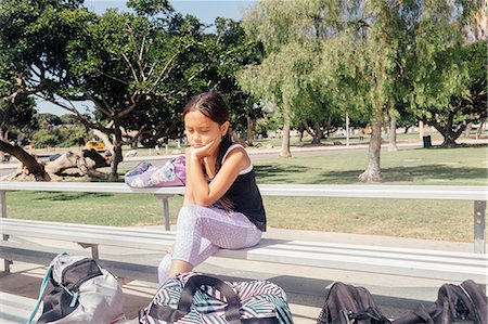 ras le bol - Schoolgirl soccer player alone on bench on school sports field Photographie de stock - Premium Libres de Droits, Code: 614-09079038