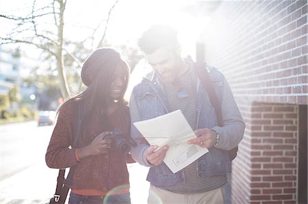 person holding a camera - Man and woman outdoors, looking at map, woman holding camera Stock Photo - Premium Royalty-Free, Code: 614-09079134