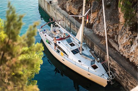 sailing - High angle portrait of man waving from yacht, Croatia Stock Photo - Premium Royalty-Free, Code: 614-09110714