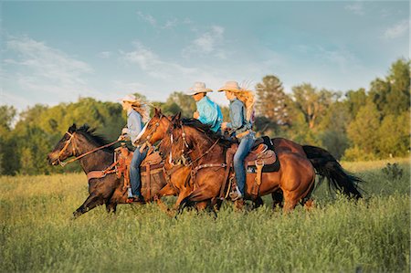 simsearch:6115-07109621,k - Group of people riding horses in field Foto de stock - Sin royalties Premium, Código: 614-09110723