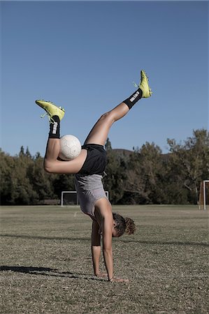 simsearch:614-07444387,k - Women on football pitch doing handstand with football Stock Photo - Premium Royalty-Free, Code: 614-09110777
