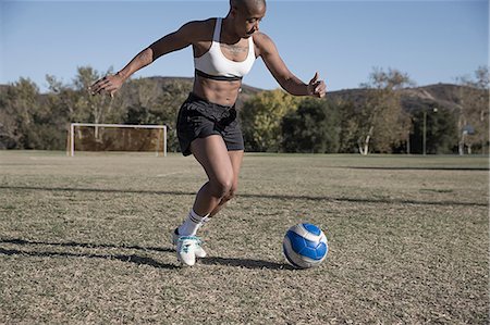 simsearch:614-08219899,k - Women on football pitch playing football Photographie de stock - Premium Libres de Droits, Code: 614-09110783