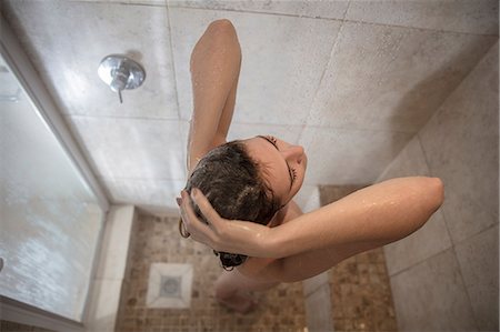 Overhead view of young woman in showering Stock Photo - Premium Royalty-Free, Code: 614-09110956