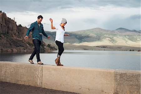 simsearch:614-09127228,k - Couple walking along wall beside Dillon Reservoir, Silverthorne, Colorado, USA Stock Photo - Premium Royalty-Free, Code: 614-09127219