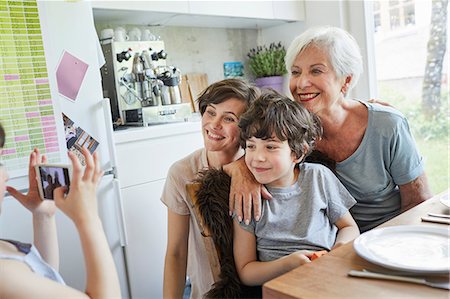 simsearch:614-09127392,k - Young girl photographing, brother, mother and grandmother, using smartphone Stock Photo - Premium Royalty-Free, Code: 614-09127365