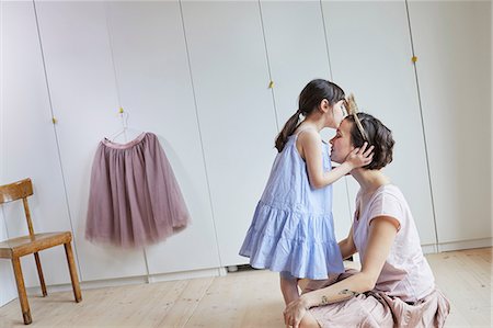 simsearch:614-09127392,k - Mother and daughter in bedroom, face to face, daughter kissing mother on head Stock Photo - Premium Royalty-Free, Code: 614-09127360