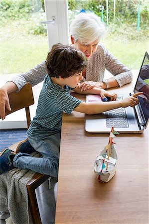 simsearch:614-08535822,k - Grandmother and grandson sitting at table, using laptop Stock Photo - Premium Royalty-Free, Code: 614-09127402