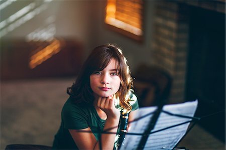 Girl daydreaming at clarinet practice Stock Photo - Premium Royalty-Free, Code: 614-09147698
