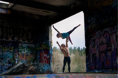 simsearch:614-08392542,k - Couple practising acroyoga on outdoor stage Stock Photo - Premium Royalty-Free, Code: 614-09147790