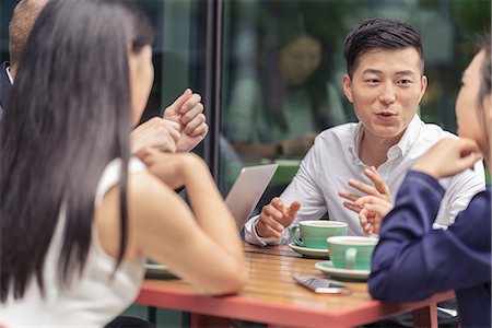 simsearch:649-08145347,k - Group of businesspeople, having meeting at cafe, outdoors Stock Photo - Premium Royalty-Free, Code: 614-09156709