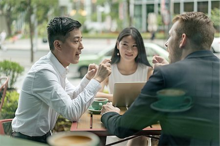 simsearch:614-09017513,k - Group of businesspeople, having meeting at cafe, using laptop, outdoors Stock Photo - Premium Royalty-Free, Code: 614-09156724