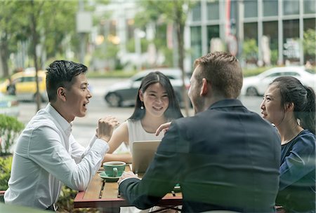 simsearch:649-08145347,k - Group of businesspeople, having meeting at cafe, using laptop, outdoors Stock Photo - Premium Royalty-Free, Code: 614-09156725