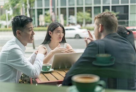 simsearch:649-08145347,k - Group of businesspeople, having meeting at cafe, using laptop, outdoors Stock Photo - Premium Royalty-Free, Code: 614-09156721