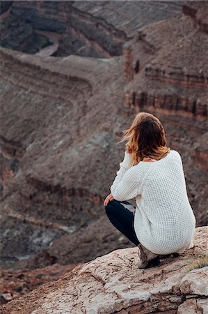 simsearch:649-09123280,k - Young woman in remote setting, crouching on rocks, looking at view, rear view, Mexican Hat, Utah, USA Stockbilder - Premium RF Lizenzfrei, Bildnummer: 614-09156748