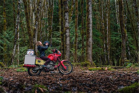 simsearch:649-09166665,k - Woman riding motorcycle in forest, Squamish, Canada Stock Photo - Premium Royalty-Free, Code: 614-09156785