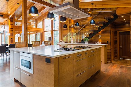 simsearch:614-09159575,k - Bamboo wood kitchen island with white quartz countertops, luxurious cedar wood home Stock Photo - Premium Royalty-Free, Code: 614-09159573