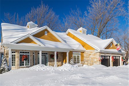 Natural cut stone with yellow wood cladding country style house facade in winter Stock Photo - Premium Royalty-Free, Code: 614-09159589