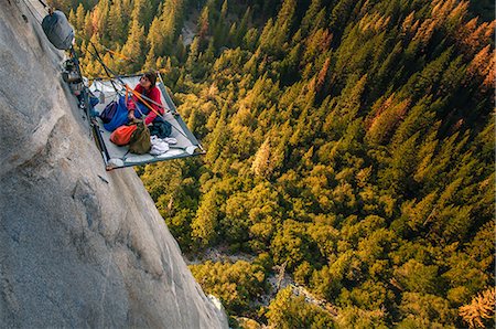 free climbing - Woman looking up from portaledge on triple direct, El Capitan, high angle view, Yosemite Valley, California, USA Stock Photo - Premium Royalty-Free, Code: 614-09159598