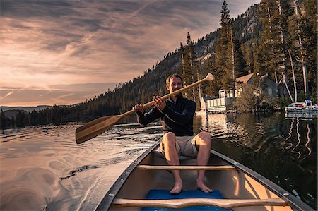 Young man canoeing on Echo Lake, High Sierras, California, USA Stock Photo - Premium Royalty-Free, Code: 614-09168120