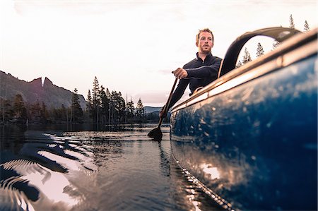 Young man canoeing on Echo Lake, High Sierras, California, USA Stock Photo - Premium Royalty-Free, Code: 614-09168121