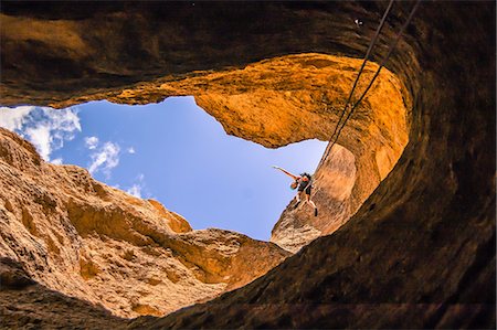 Man abseiling, low angle view, Smith Rock State Park, Terrebonne, Oregon, United States Stock Photo - Premium Royalty-Free, Code: 614-09168159