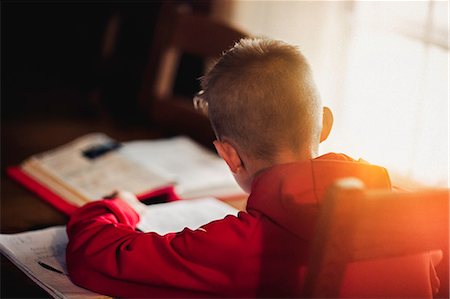 Boy doing homework Stock Photo - Premium Royalty-Free, Code: 614-09168164