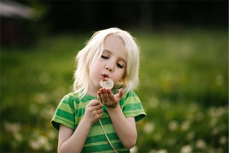 Boy blowing dandelion Stock Photo - Premium Royalty-Free, Code: 614-09168174