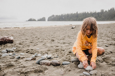 Girl playing on beach, Tofino, Canada Stock Photo - Premium Royalty-Free, Code: 614-09178145