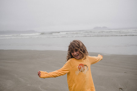 Girl playing on beach, Tofino, Canada Stock Photo - Premium Royalty-Free, Code: 614-09178143