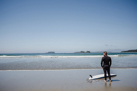 Man with surfboard on beach, Tofino, Canada Stock Photo - Premium Royalty-Free, Code: 614-09178155