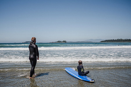 Father and daughter surfing on beach, Tofino, Canada Stock Photo - Premium Royalty-Free, Code: 614-09178153
