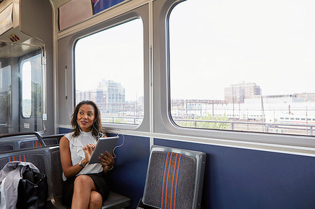 Businesswoman using digital tablet on train Stock Photo - Premium Royalty-Free, Code: 614-09178286