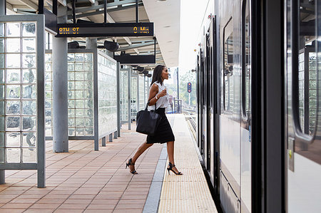 people commuting on trains - Businesswoman boarding train Stock Photo - Premium Royalty-Free, Code: 614-09178289