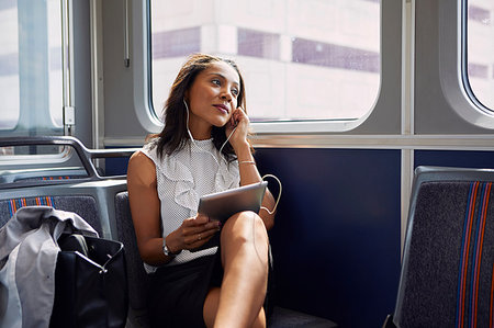 finance african american not child not teenager - Businesswoman using digital tablet on train Stock Photo - Premium Royalty-Free, Code: 614-09178282