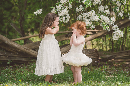 Sisters making faces at each other Stock Photo - Premium Royalty-Free, Code: 614-09198184