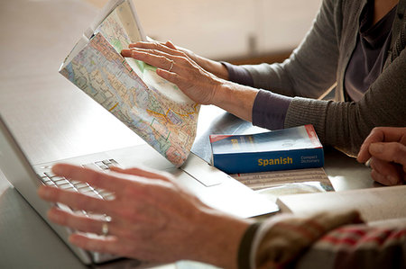 Older couple reading map and laptop Stock Photo - Premium Royalty-Free, Code: 614-09209848