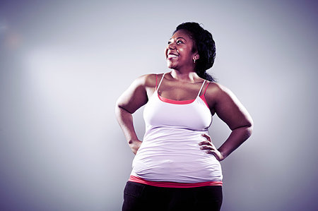 Mid adult woman wearing white vest, hands on hips Photographie de stock - Premium Libres de Droits, Code: 614-09209925