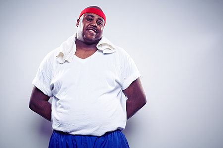 Portrait of man wearing white t shirt and sweatband Stock Photo - Premium Royalty-Free, Code: 614-09209953