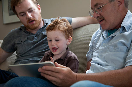 Boy looking at digital tablet with father and grandfather Photographie de stock - Premium Libres de Droits, Code: 614-09210059