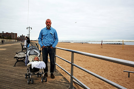 simsearch:649-08564303,k - Man with baby boy in push chair at seaside Stock Photo - Premium Royalty-Free, Code: 614-09210155