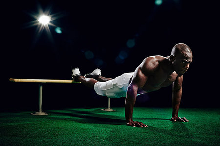 simsearch:649-09207338,k - Bare chested american footballer doing press ups Stock Photo - Premium Royalty-Free, Code: 614-09210360