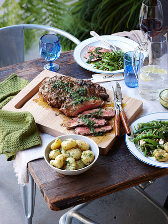 simsearch:649-08423293,k - Dinner table with barbecued herb crust lamb and spring greens Stock Photo - Premium Royalty-Free, Code: 614-09210590