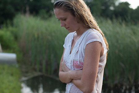 pic of person head down arms crossed - Teenage girl walking by marshes Stock Photo - Premium Royalty-Free, Code: 614-09210822