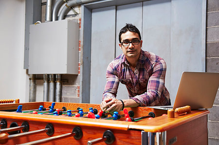 simsearch:614-06403067,k - Portrait of young man leaning on table football Stock Photo - Premium Royalty-Free, Code: 614-09210926