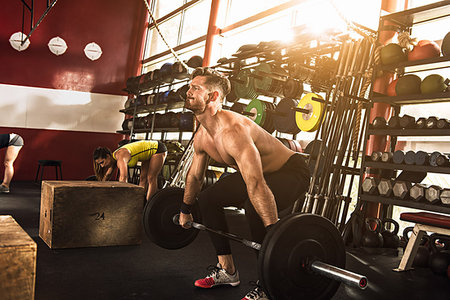 simsearch:649-07648175,k - Bodybuilder bending to lift barbell in crossfit gym Stock Photo - Premium Royalty-Free, Code: 614-09211245