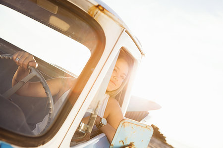 simsearch:614-08202342,k - Young female surfer looking out from pickup truck window Stock Photo - Premium Royalty-Free, Code: 614-09211330