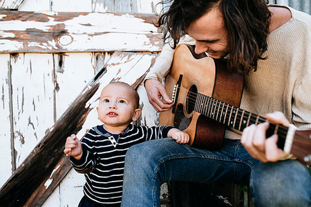 Father entertaining son with guitar Stock Photo - Premium Royalty-Free, Code: 614-09211364